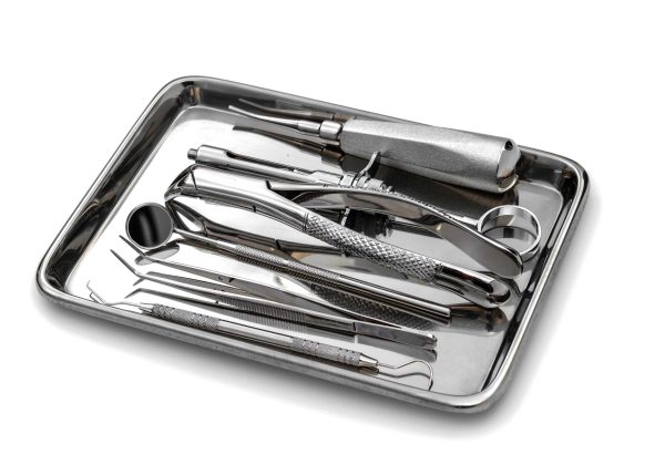 Dental tools and equipment on white background.